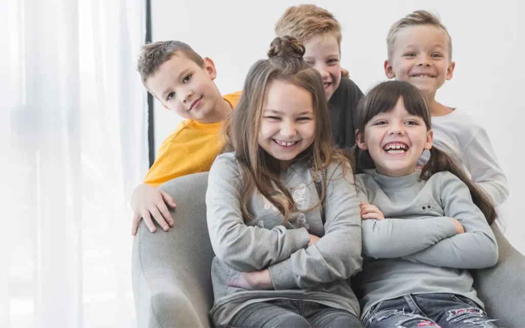 Group of happy children sitting on armchair